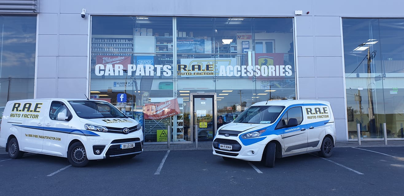 Two rally cars outside RAE Motor Factors store